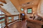 Open area in the loft offers a comfortable spot for reading